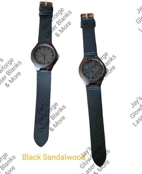 Two black sandalwood watches with leather bands and blue stitching, one with a black strap and the other with a brown strap, both with a silver case and blue hands.